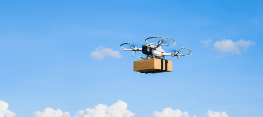 Delivery drone fly with package box on blue sky with copy space, technology transportation service in the future concept, logistics, banner