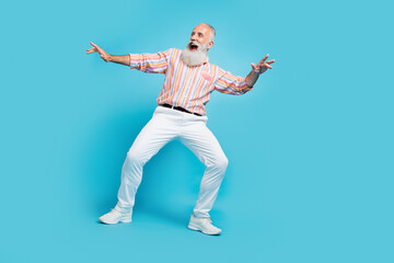 Full body photo of handsome excited aged man happy positive smile dance discotheque isolated over blue color background