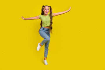 Fototapeta na wymiar Full length body size view of attractive cheerful girl dancing flying having fun isolated over bright yellow color background
