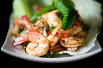 Thai food - spicy Shrimp salad with garlic and basil