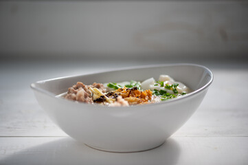 Thai style clear soup rice noodle in traditional bowl. Selective focus