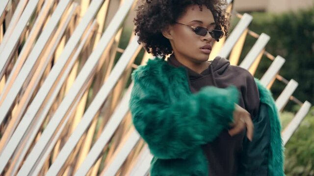 Stylish African American woman in trendy wear dancing rnb outdoor, dancer