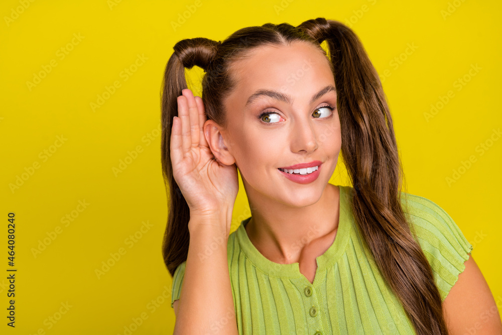 Poster Portrait of attractive cheerful funny girl overhearing copy space advert isolated over vibrant yellow color background