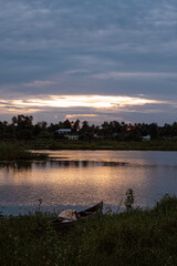 Boat by the lake, beautiful summer evening Beautiful sunset with red sky