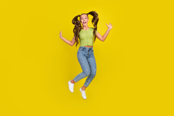 Fototapeta na wymiar Full length body size view of pretty cheerful girl jumping fooling having fun isolated over bright yellow color background