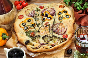 Focaccia with red wine on wooden background