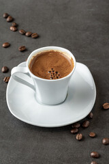 Obraz na płótnie Canvas Turkish coffee over smoke and coffee beans on dark stone table