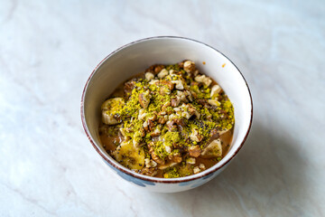 Oatmeal Porridge with Milk Jam, Walnut and Pistachio Powder.