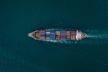 containers ship corgo transport floating at sea aerial top view