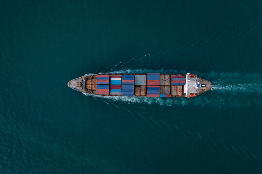 containers ship corgo transport floating at sea aerial top view