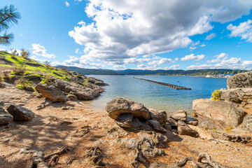 View from the lower hiking trail on Tubbs Hill reserve of the lake and mountains near downtown in the rural resort city of Coeur d'Alene, Idaho, USA.