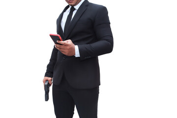 A gun man in black suit is holding a pistol and his other hand is going to his mobile to check his...