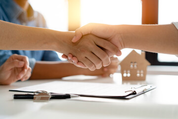 Hand of broker showing information of contract to client before sign signature in mortgage contract.
