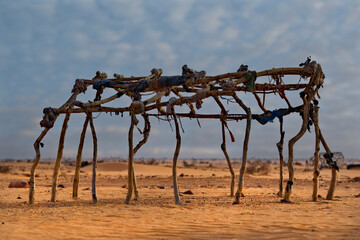 West Africa. Mauritania. A frame made of wooden sticks tied with fabric scraps in a settlement of nomads of the Sahara Desert. Such frames are sheathed with animal skins and dense fabrics.