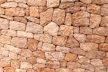 Light brown sandstone wall, stone wall background.