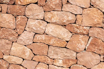 Light brown sandstone wall, stone wall background.