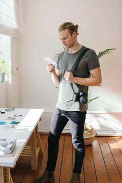 Photographer in his studio reviewing looking at a photo