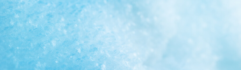 Snowy background with closeup view of the crystal snowflakes
