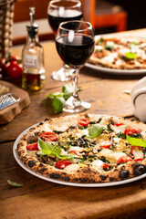 Pizza Napolitana or Naples style with mozzarella, mushrooms and spinach