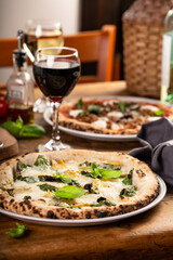 Pizza Napolitana or Naples style with cheese, mushrooms and basil