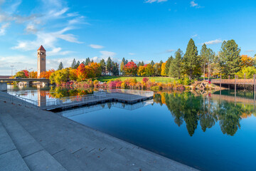 Autumn view with leaves turning Fall colors near the clock tower along the Spokane River at...