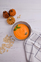 pumpkin soup in a bowl in a white background
