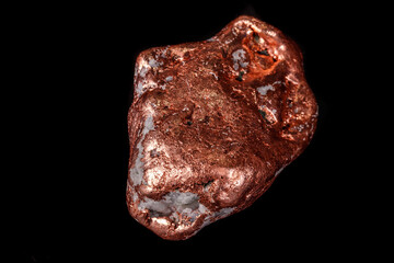 Macro mineral stone of a copper nugget on a microcline on a black background