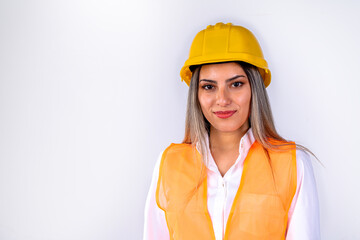 Beautiful young female engineer or supervisor, wearing safety equipment, on white background with room for text or copy space. Concept of empowered woman, professional woman, professional job.