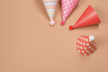 Colorful birthday cap on brown  background.