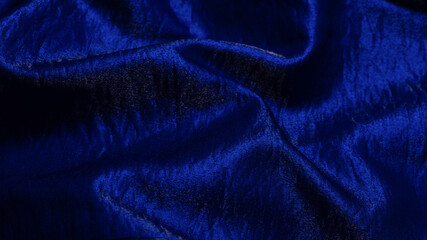 Purple shiny fabric as background. Top view.