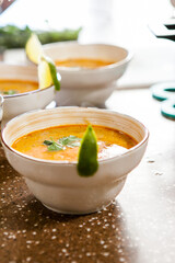 Asian hot red soup in a clay bowl on the table