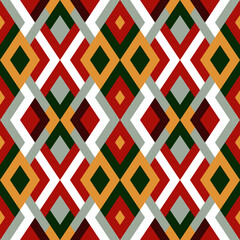 Abstract seamless pattern. Vector geometric background of triangles in green, red and yellow colors. Mosaic texture for textile, clown, carpeting, warp, book cover, clothes