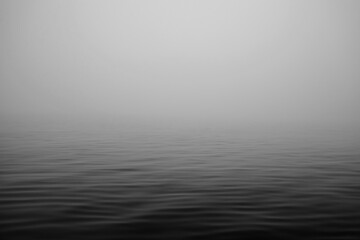 Moving ocean waves in fog black and white.  - 464099619