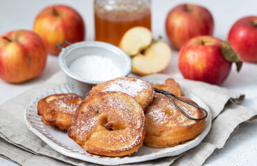 Sweet pancakes with apples, cinnamon and powdered sugar