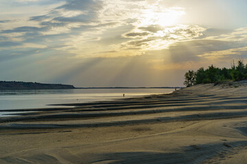 Sunset over a sandy beach on the Volga river, Russia.