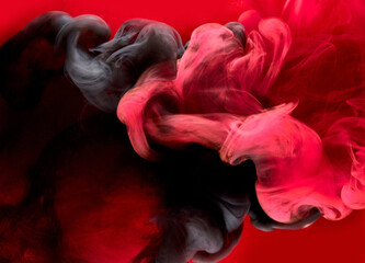 Red black pigment swirling ink abstract background, liquid smoke paint underwater