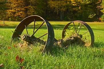 Old rusty farm equipment in a meadow