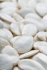 Pumpkin seeds in a shell as a textural background.