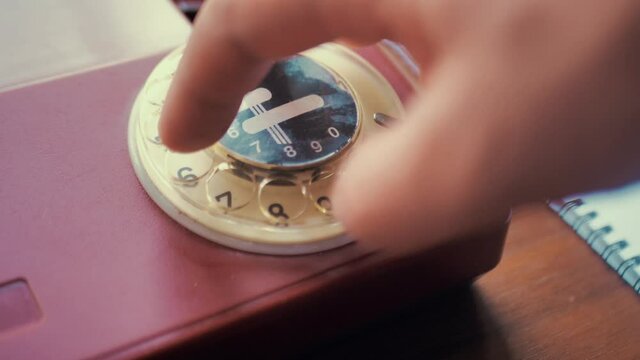 Ringing A Red Rotary Dial Telephone. Dialing On An Old Rotary Style Telephone. Red Vintage Phone. Retro Phone Ringing Off The Hook