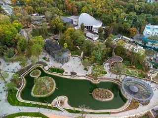 Foto op Canvas Autumn city aerial look down view on Kharkiv zoo lake surrounded by greenery and walking paths. Recreation area in Ukraine © Kathrine Andi
