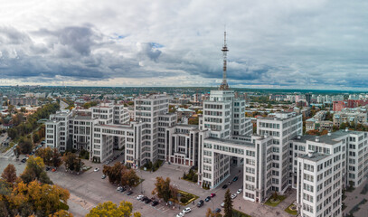 Aerial view on autumnal Derzhprom historic constructivist architecture building from Freedom Svobody Square with dramatic clouds in Kharkiv city, Ukraine