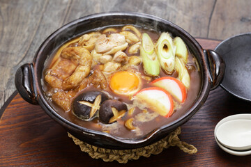 Miso Nikomi Udon is Japanese noodle soup dish stewed in miso broth. and that is very popular in Nagoya area.
 ingredients are chicken, shiitake mushrooms, fried tofu, kamaboko, egg and green onion.