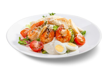 Fototapeta na wymiar caesar salad with shrimps on a white plate, close-up, isolate