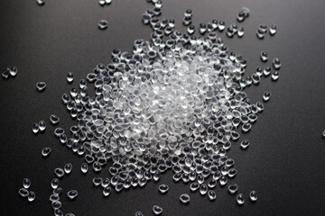 White granules of rubber, polypropylene or polyamide on a black background