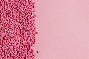 Pink granules of polypropylene or polyamide. background. Plastics and polymers industry. Monochrome