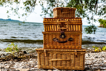 close up of picnic baskets on the beach 