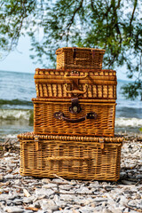 stack of picnic baskets on the beach 