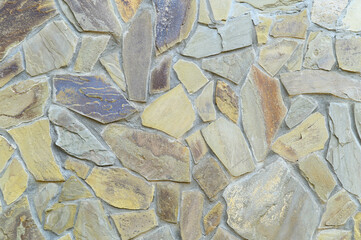 Fragment of a wall, lined with tiles made of polished natural stone