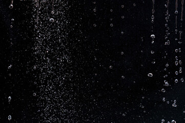 air bubbles in the water isolated on black background
