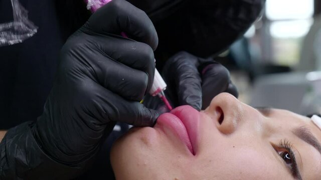 Microblading lip tattoo with special coloring pigment that corrects lip color in cosmetology clinic